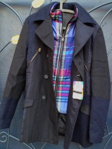 This is a new Desigual jacket that has double-breasted buttons, zip pockets in front and has a snappy blue-plaid vest that is removable.